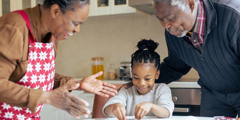 a young girl bakes with her grandparents