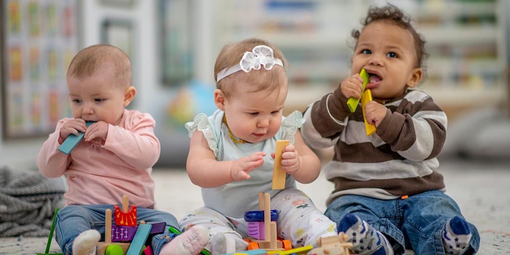 three small children playing in daycare