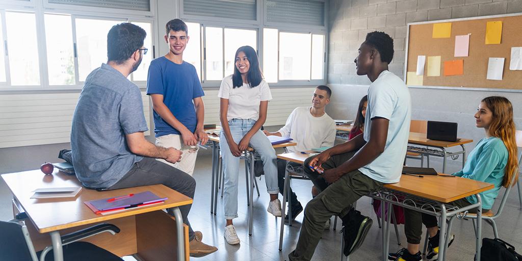 students and a teacher having a conversation