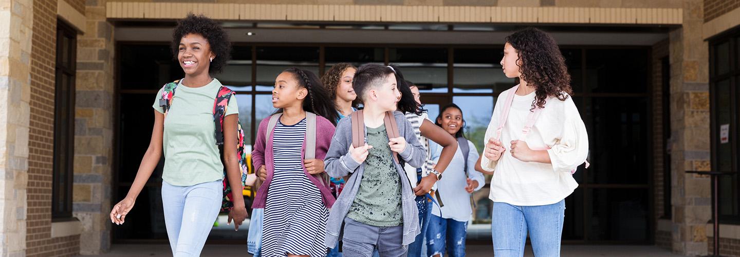 a group of children leave the school