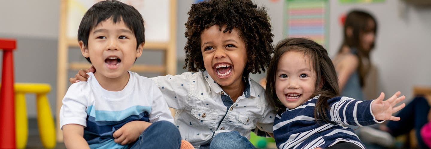 happy children smile together in a preschool classroom